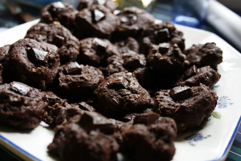 there are a lot of brownies on a white plate