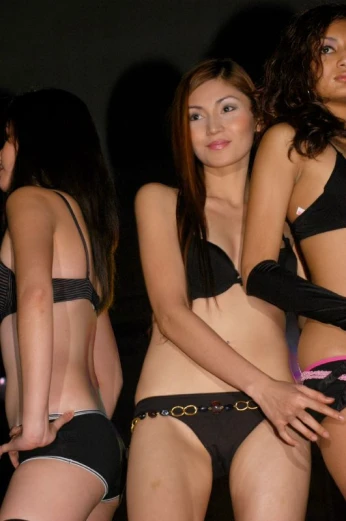 three models in lingerie with black s and lace garter