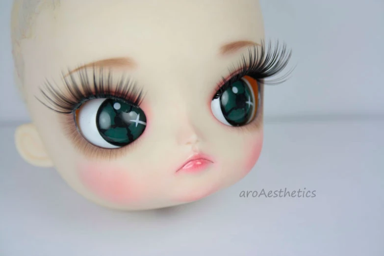 a close up of a doll with very big eyes