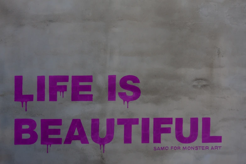 the word life is beautiful painted on the side of the wall
