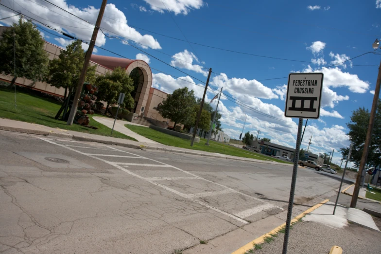 a street with a railroad crossing in the middle