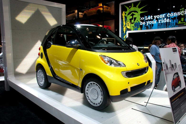 a small car on display on a white surface