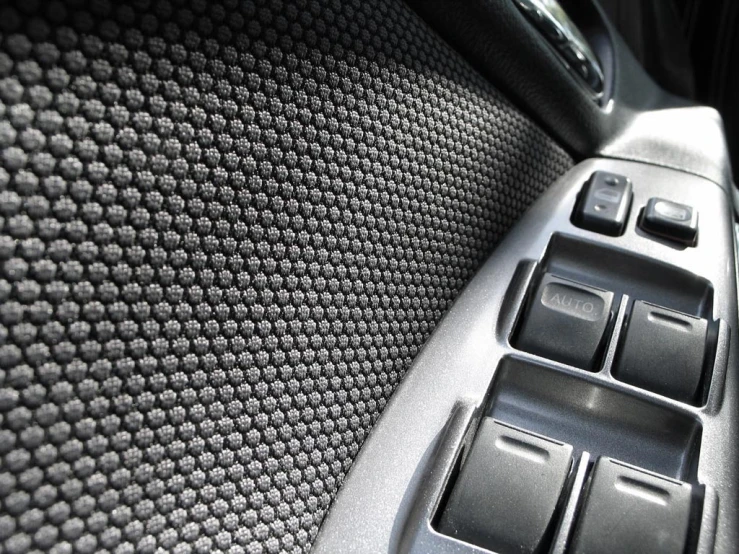 a grey car interior with ons and black stitchs