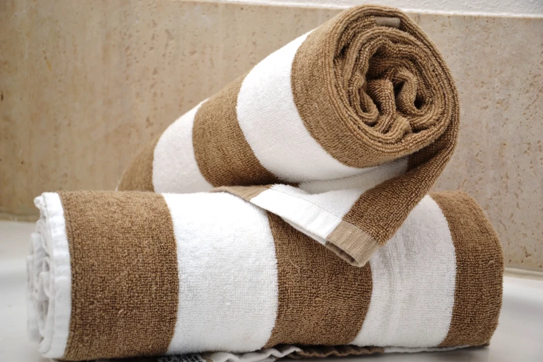 two towels rolled up next to each other on a table