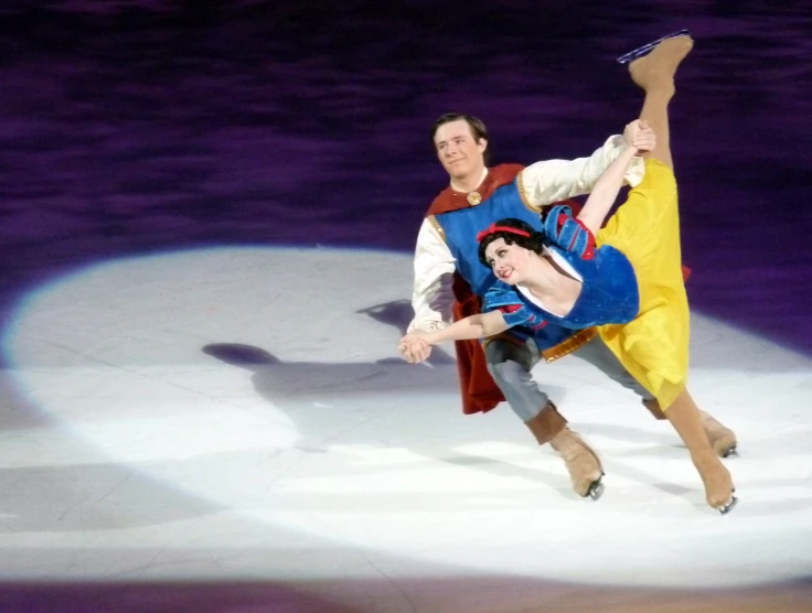 two people dressed in costume skating on ice