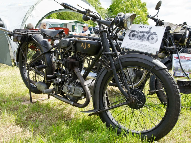 an old fashioned motorcycle is on display with others