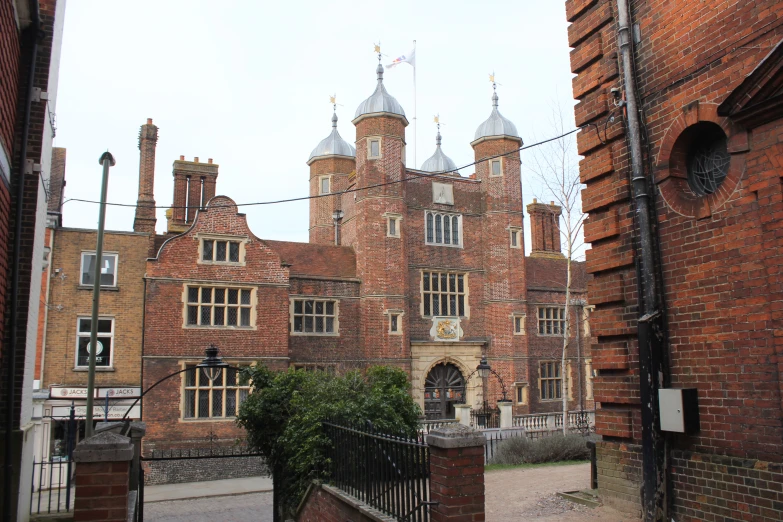 a large red brick building with two towers