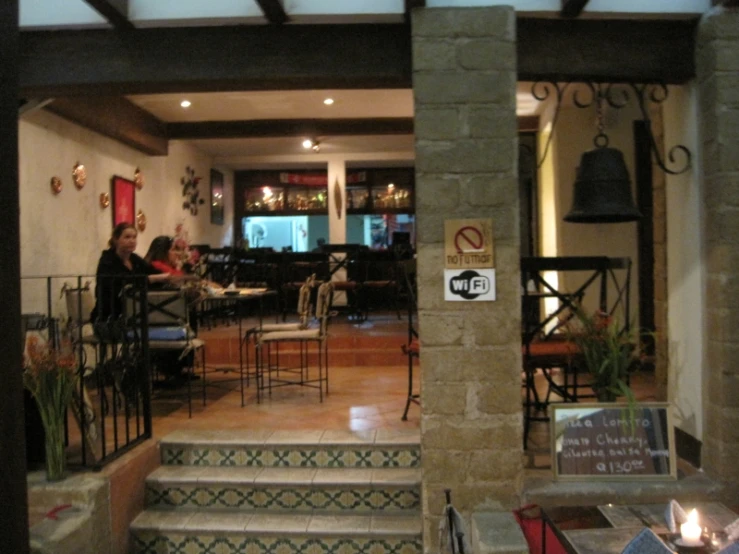 view from the outside of an outdoor restaurant with tables and chairs