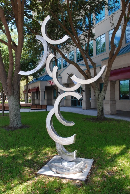 a large modern sculpture stands in the grass