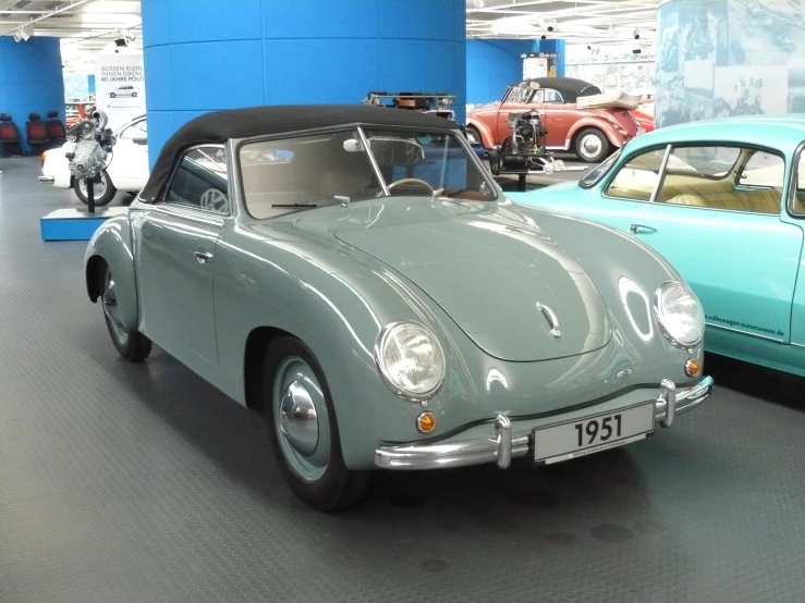 an old car and an older one are displayed