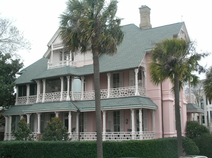 this old pink house has balconyes and balconies