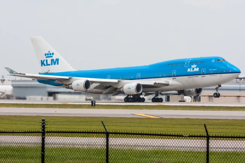 blue and white passenger jet on tarmac at airport