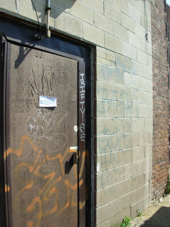 graffiti on the door to a building that looks like a factory