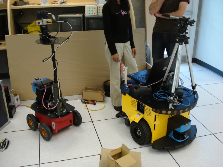 two women look at video equipment in an office