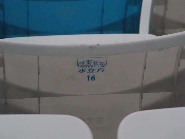 a group of white chairs that are sitting in the shade