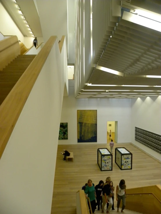 group of people walking up an indoor walkway