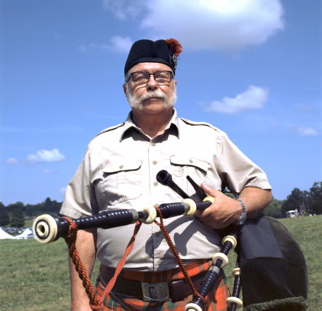 a man in the field has two bagpipes attached