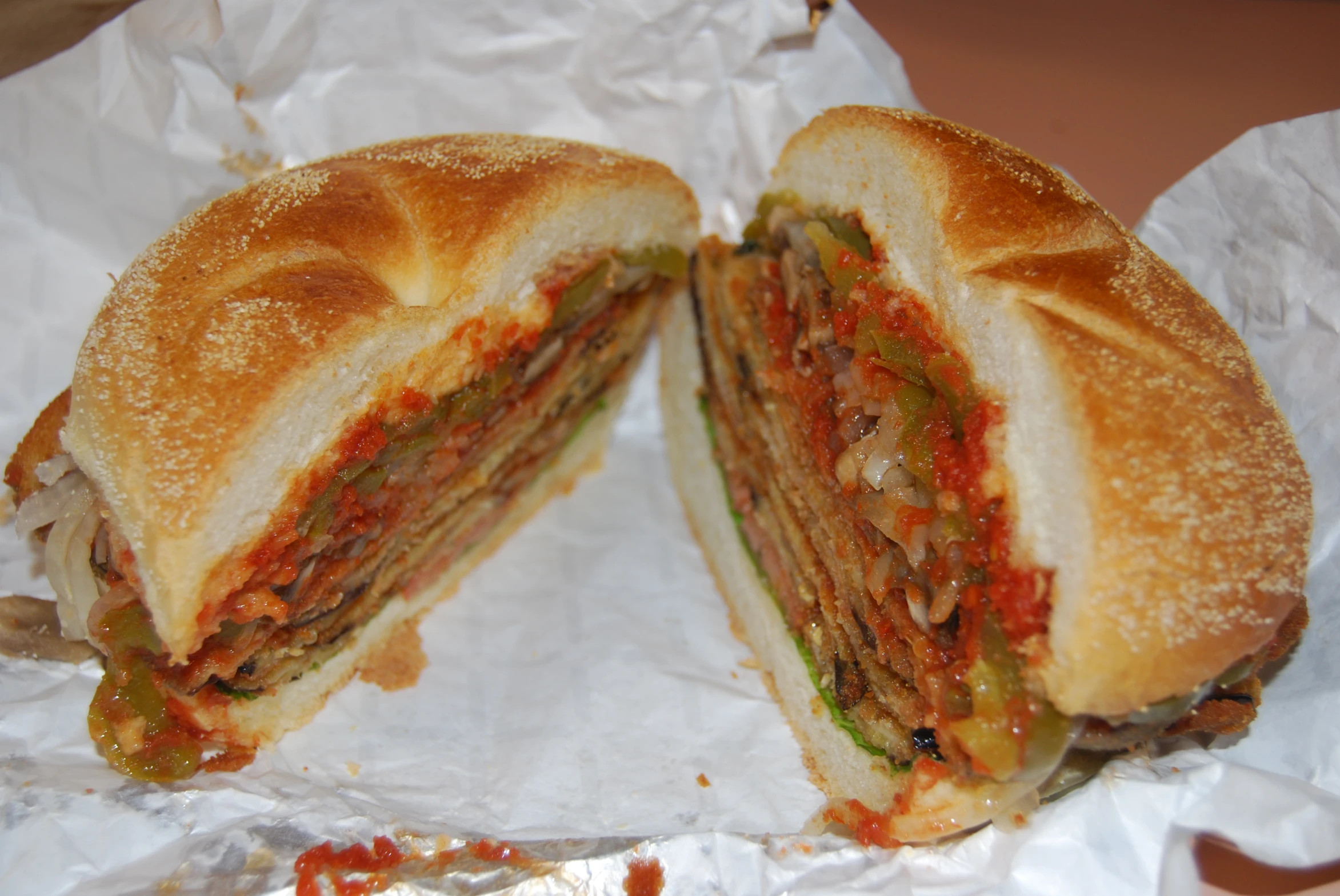 a sandwich sitting on top of a piece of white wax