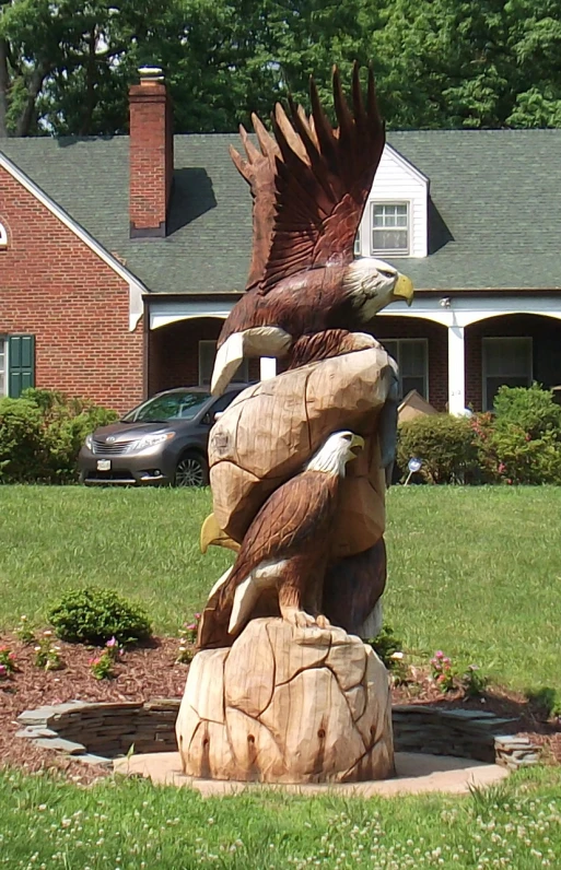 a statue in front of a big house