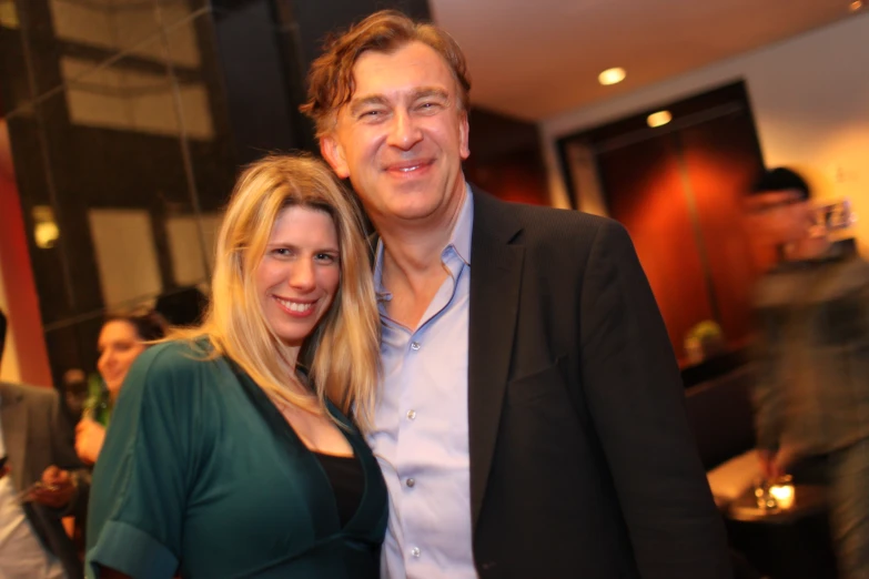 a man and woman standing together at a restaurant