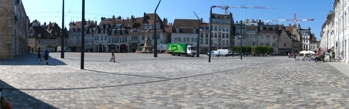 an empty street with tall buildings near by