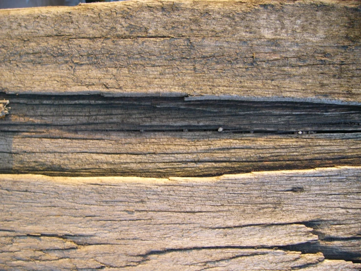 a close up of wood surface with holes