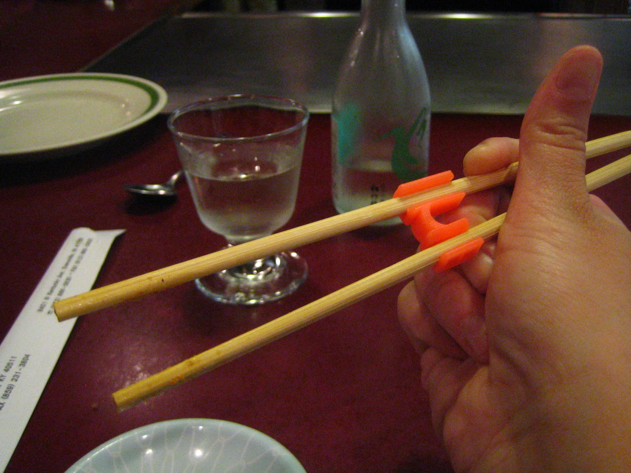 a person holding up chopsticks with some chopstick in hand