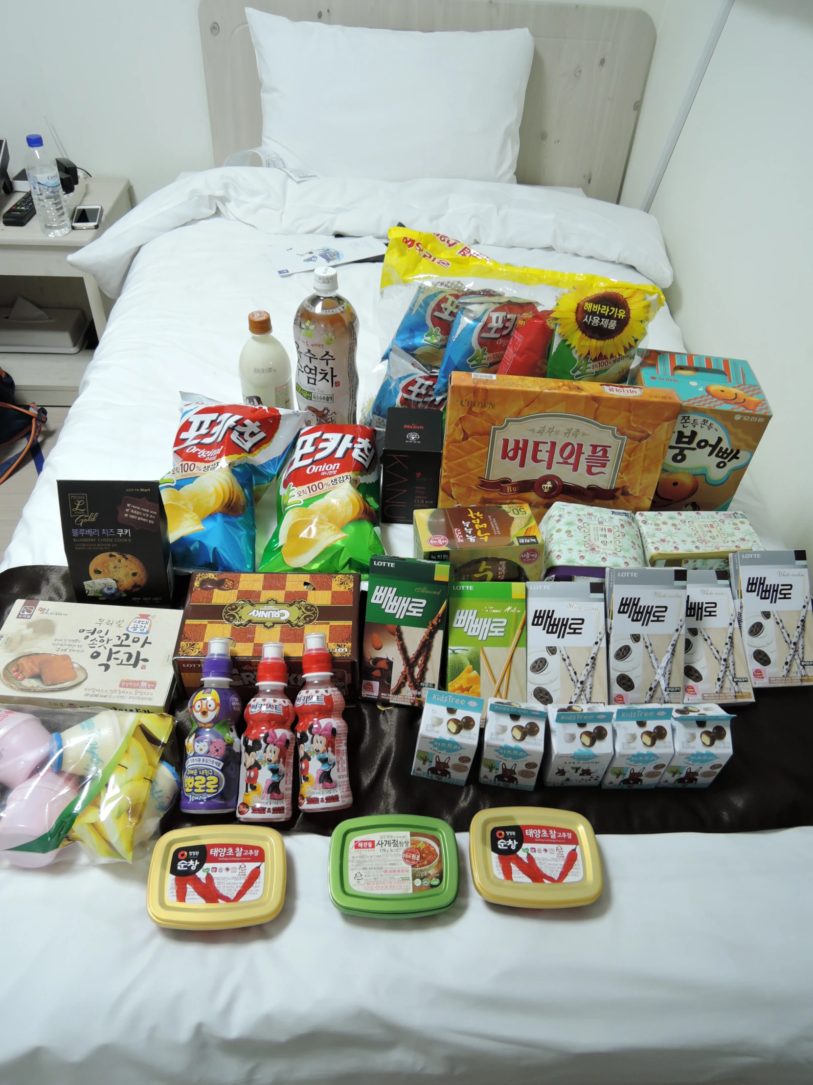 a bed that has food and various condiments laid out on it