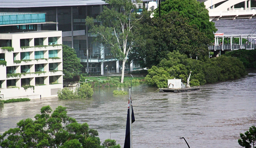 flooded area with trees in front of buildings