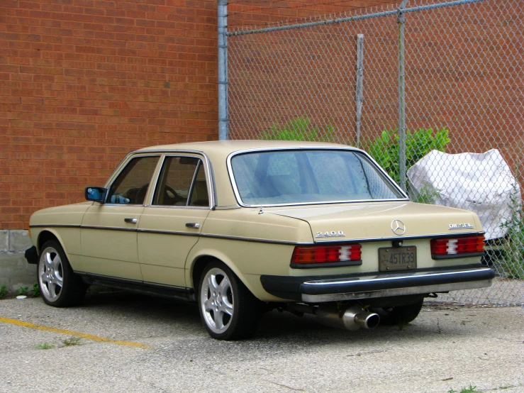 an old car sits in a parking lot with its tailgate out