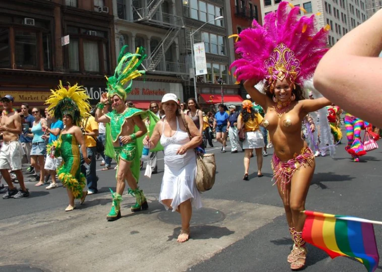 women in costumes walk down the street