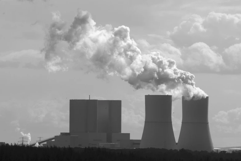 smoke billows from the stacks of cooling pipes