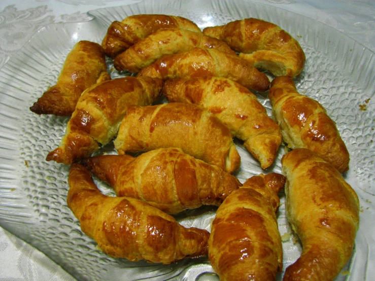 this is some croissants sitting on a plate