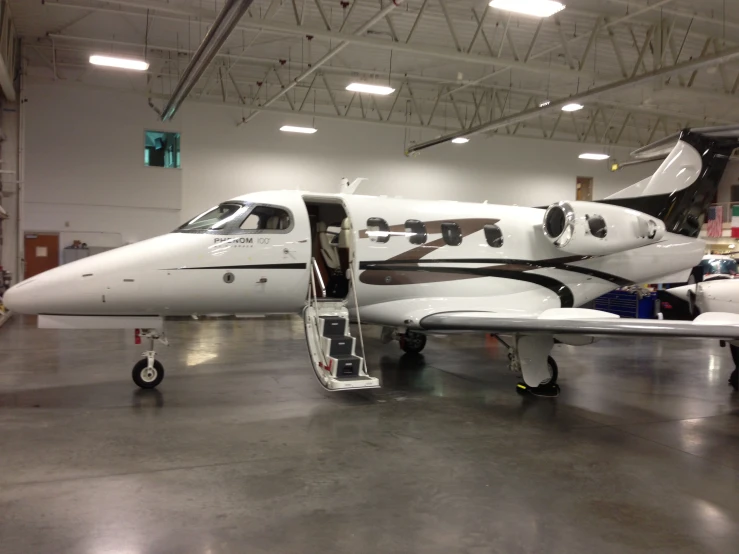 a large jetliner sitting inside of a hangar filled with windows