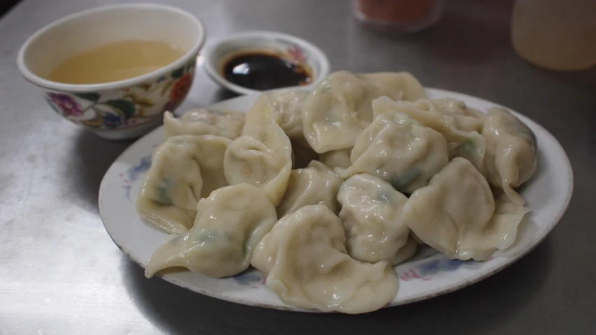 plate of dumplings and tea on table next to coffee