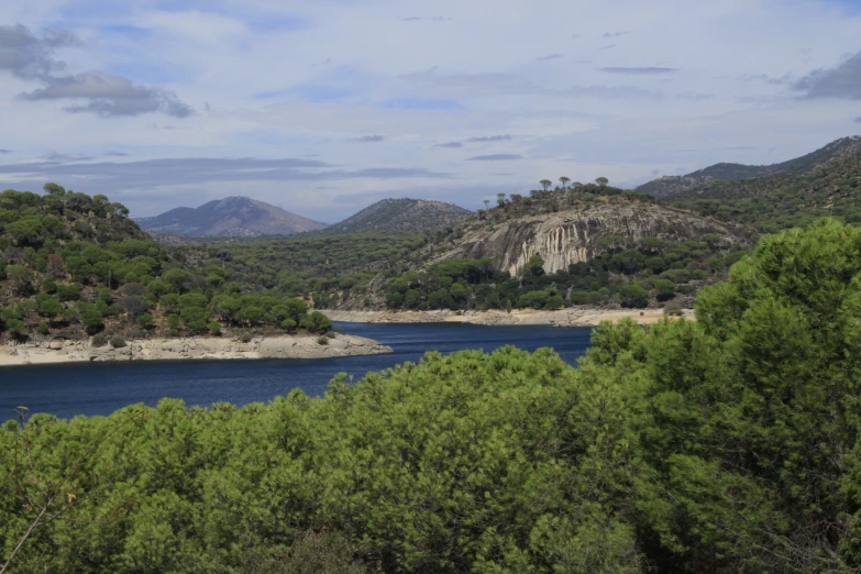 the green foliage and rocky mountains surrounding the lake