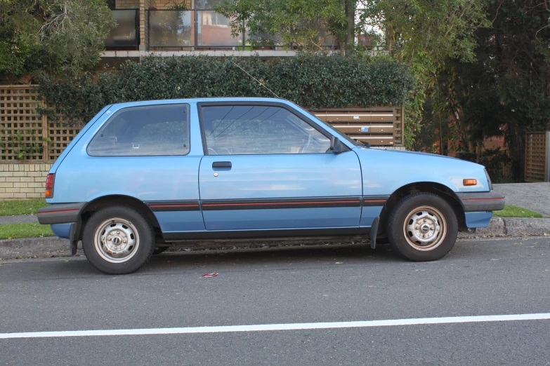 a blue pick up truck parked next to a residential building