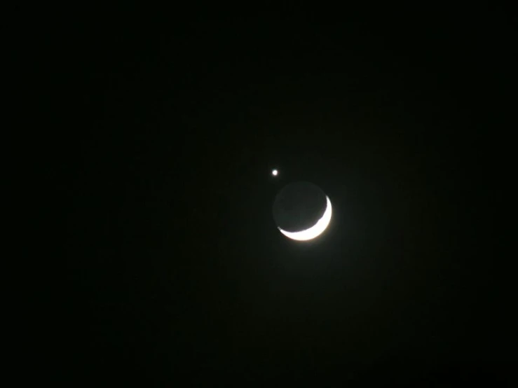 moon seen through telescope lens in dark sky