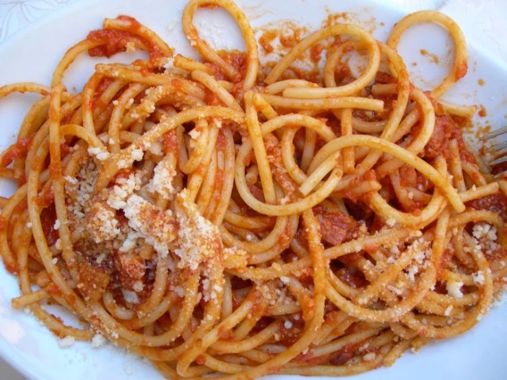 an empty plate with a pasta dish being cooked