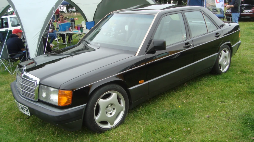 an older style mercedes benz is on display in a field