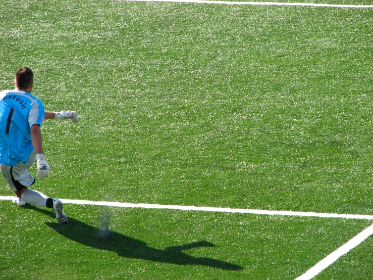 a man on a field with soccer equipment