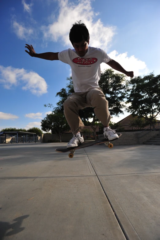 a skate boarder performs a trick on a concrete surface