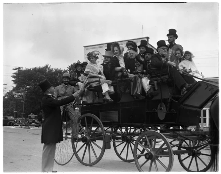 people on a wagon being pulled by two horses