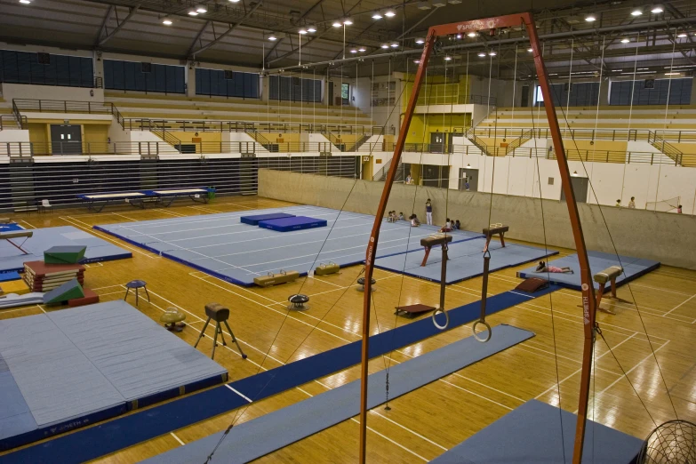 an indoor gym with overhead gym equipment