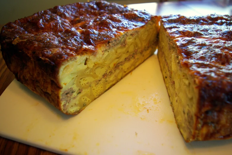 two slices of meatloaf sitting on a  board