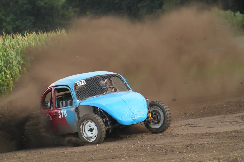 a dirt buggy with two people riding on it