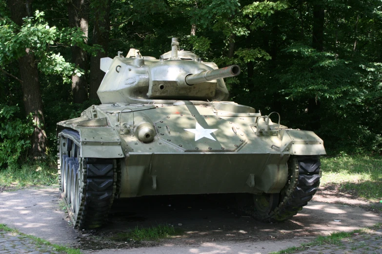 the tank is painted green and white and sits in the park