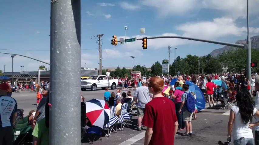 a crowd of people standing around at an intersection