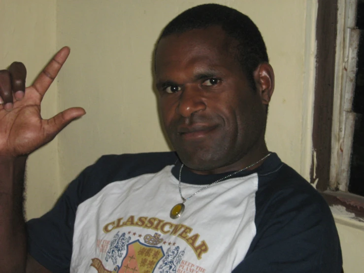 a man wearing a t - shirt that says classic air with his hand extended and the word american flag on it