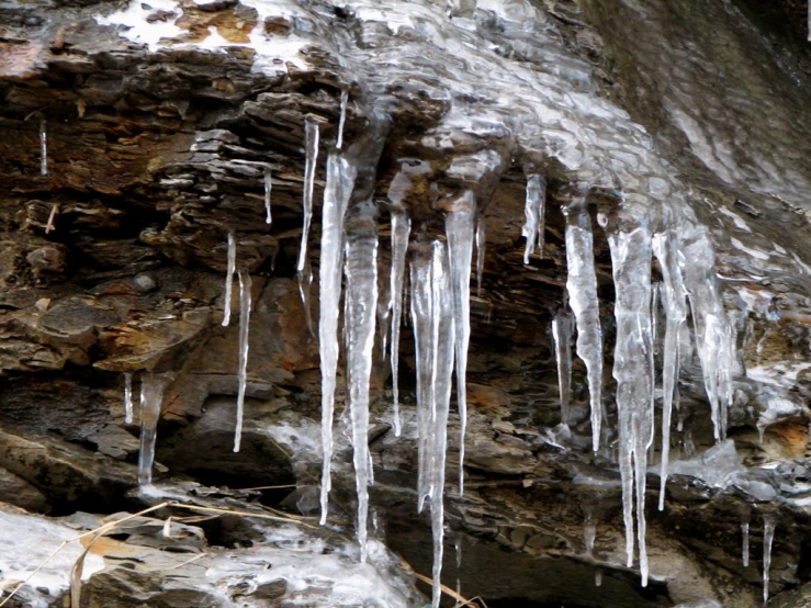 icicles hanging on the side of a mountain wall